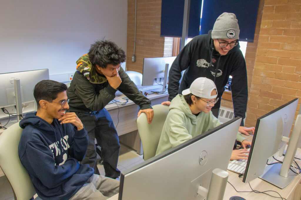 GWD Students Giving feedback to eachother in the computer lab.